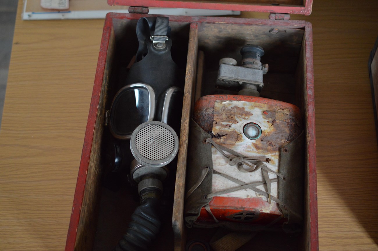 A smoke mask in a wooden box.