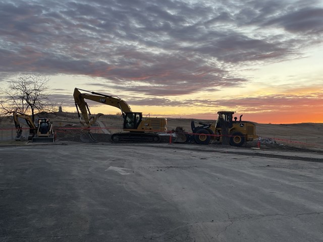 Large construction equipment sit where an old visitor center used to stand. 