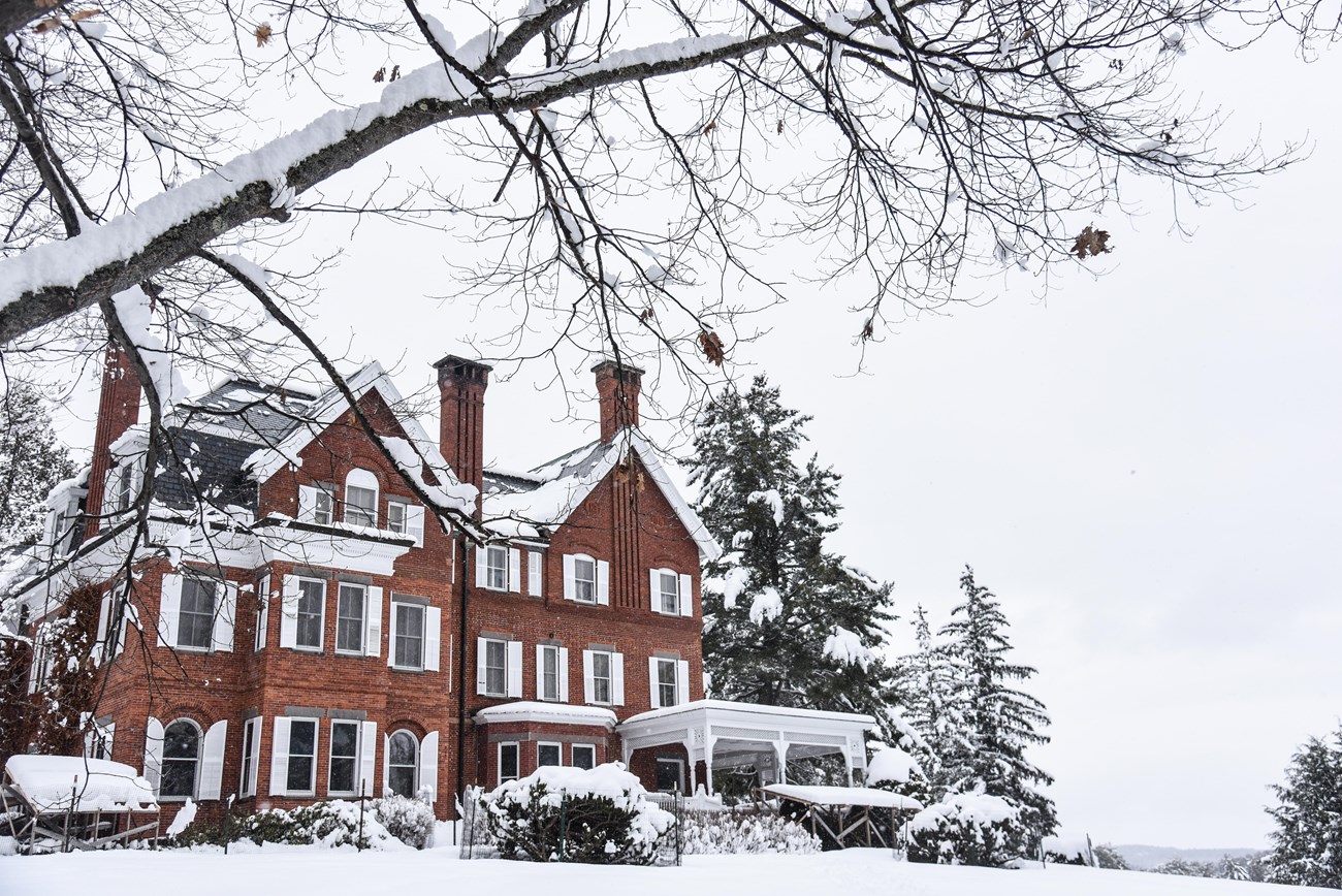 red brick mansion covered in snow