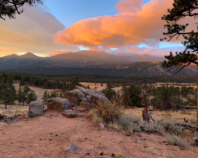 Rock outcropping with mountains at sunrise.