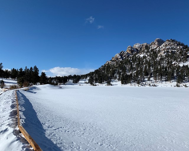 Snow covered lake and boardwalk.