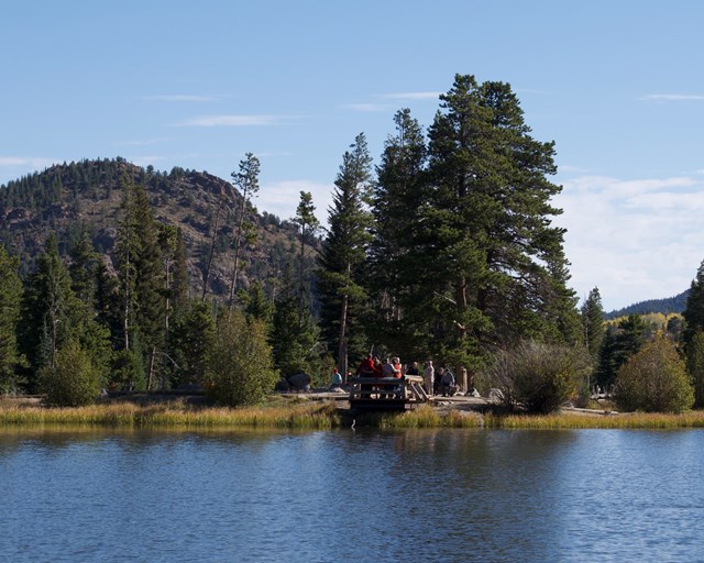 Lake with a dock and mountain.