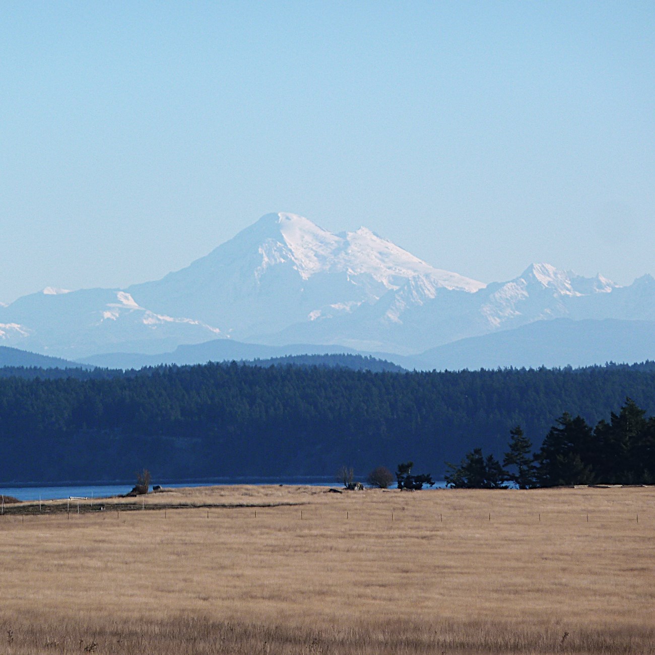 A tall snowy mountain seen in the distance