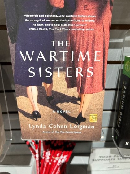 Picture of book cover.  Shows two women in dresses.