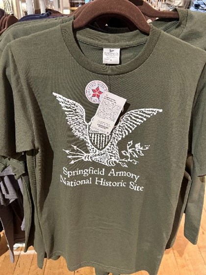 Picture of green t-shirt with drawing of eagle clutching arrows in the talons.