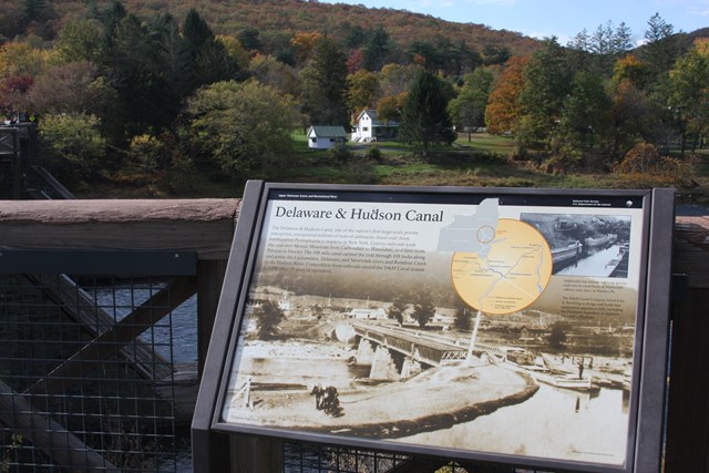 Wayside exhibit attached to outdoor railing.