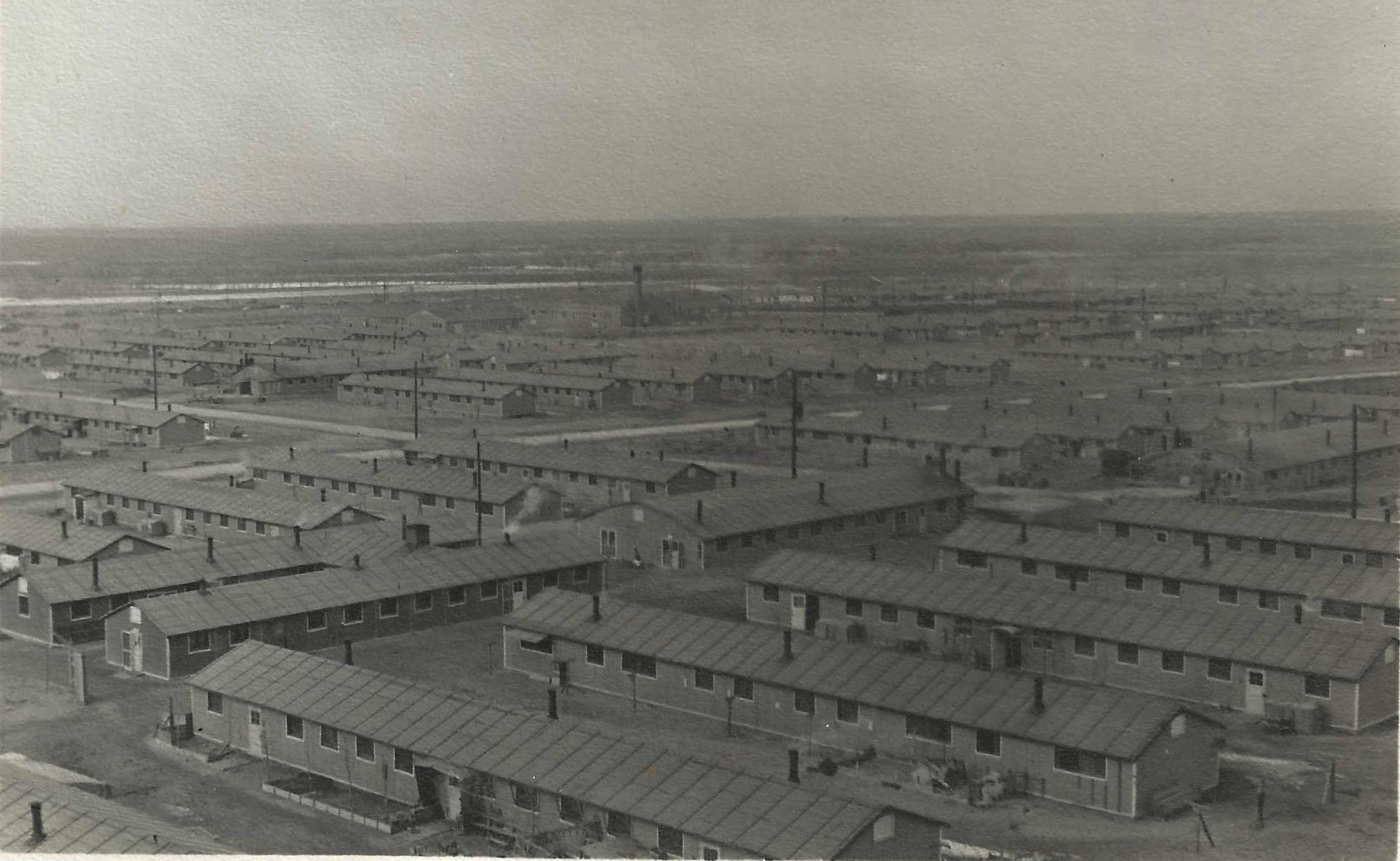 looking down on what appears to be a city with rows of army barracks