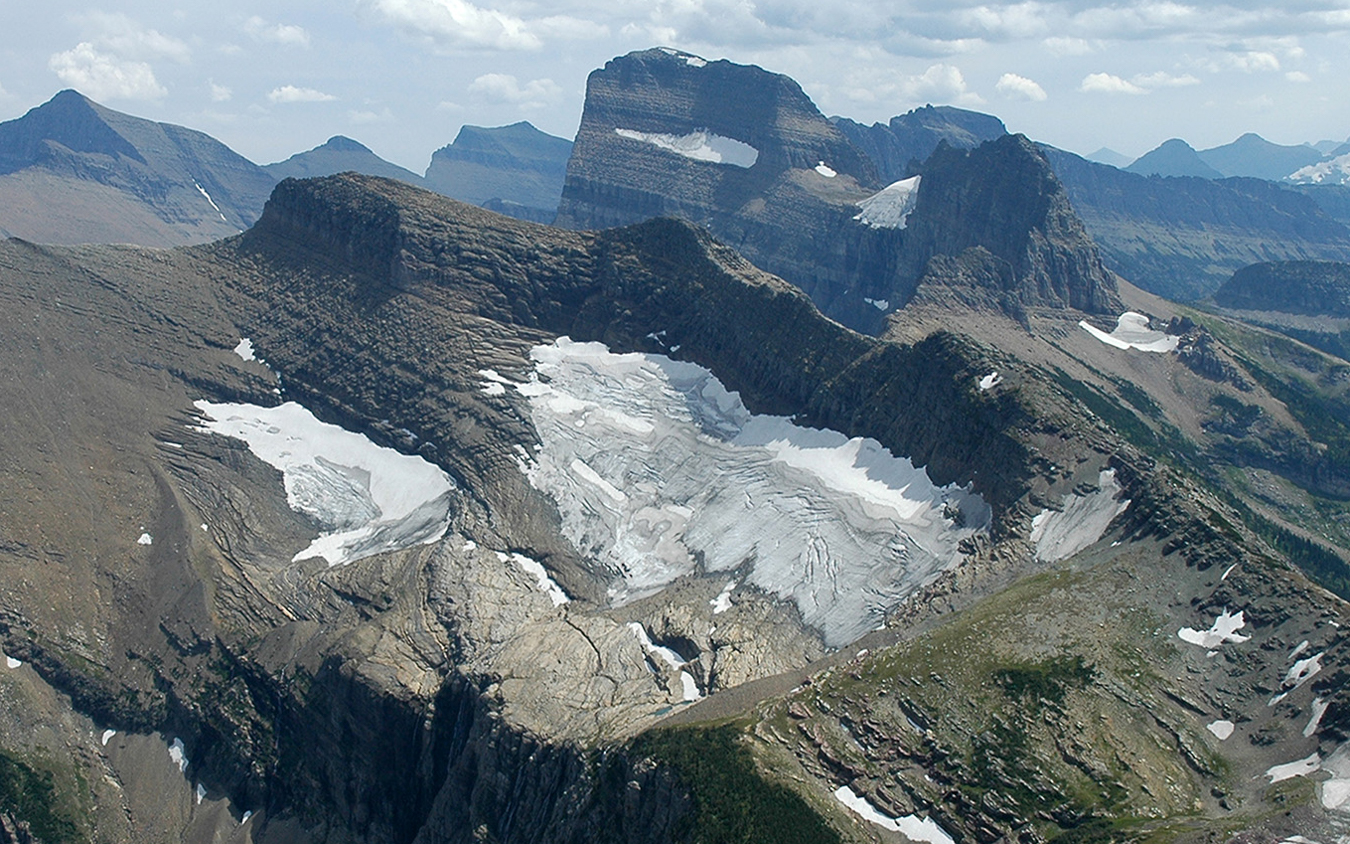 Landscape of an alpine glacier with mountains behind.