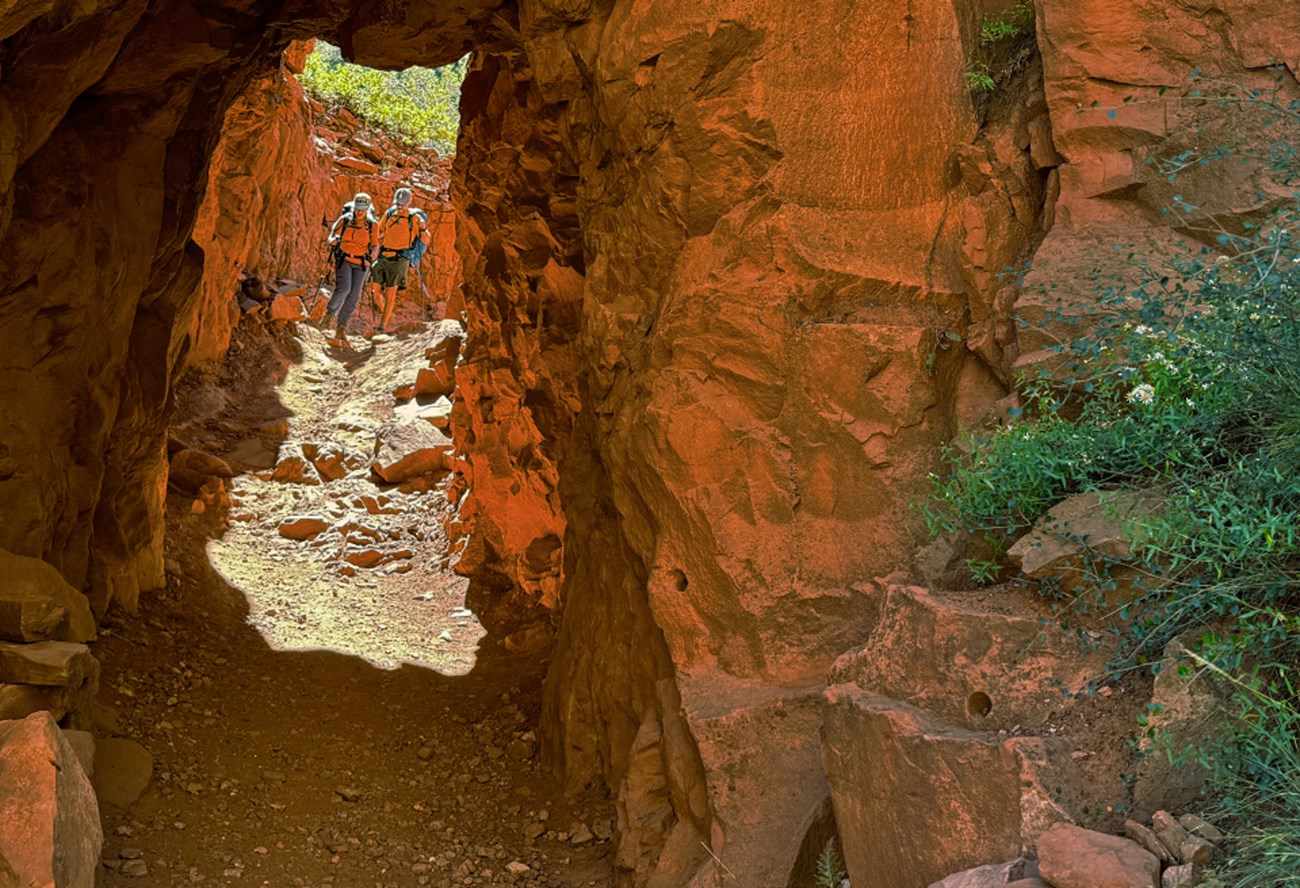 Man standing in tunnel carved through rock