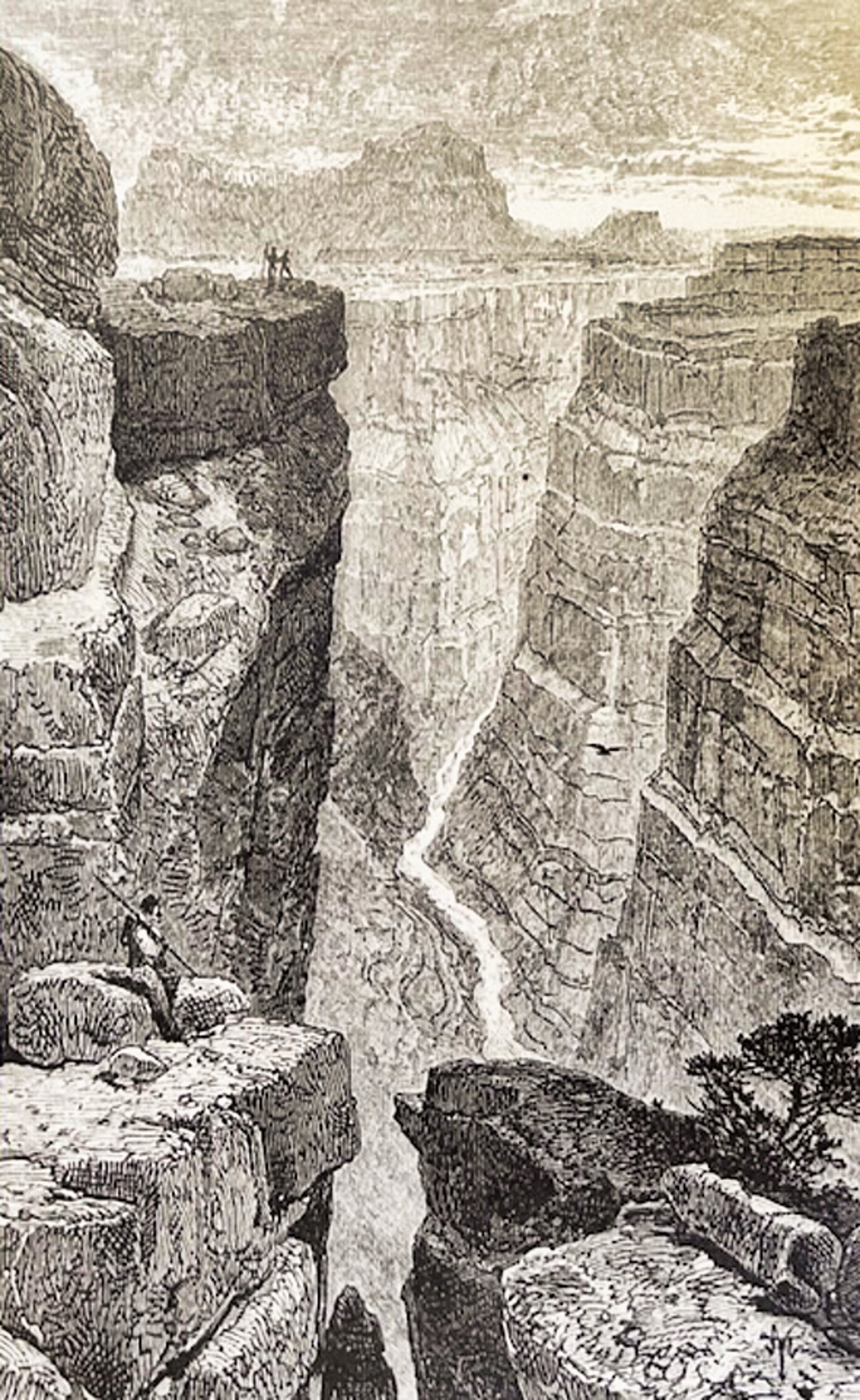 Men at edge of cliff looking down on river