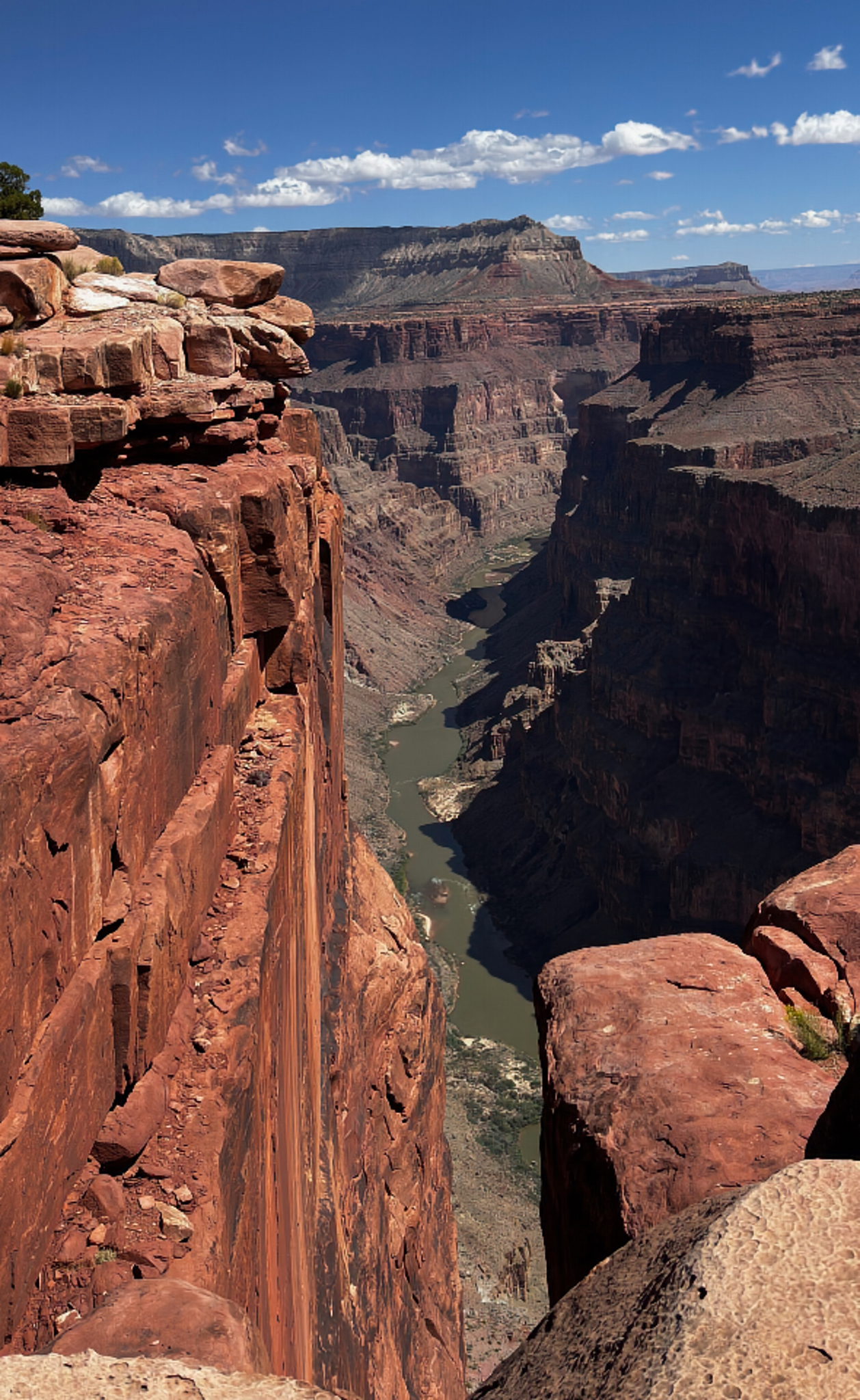 Men at edge of cliff looking down on river