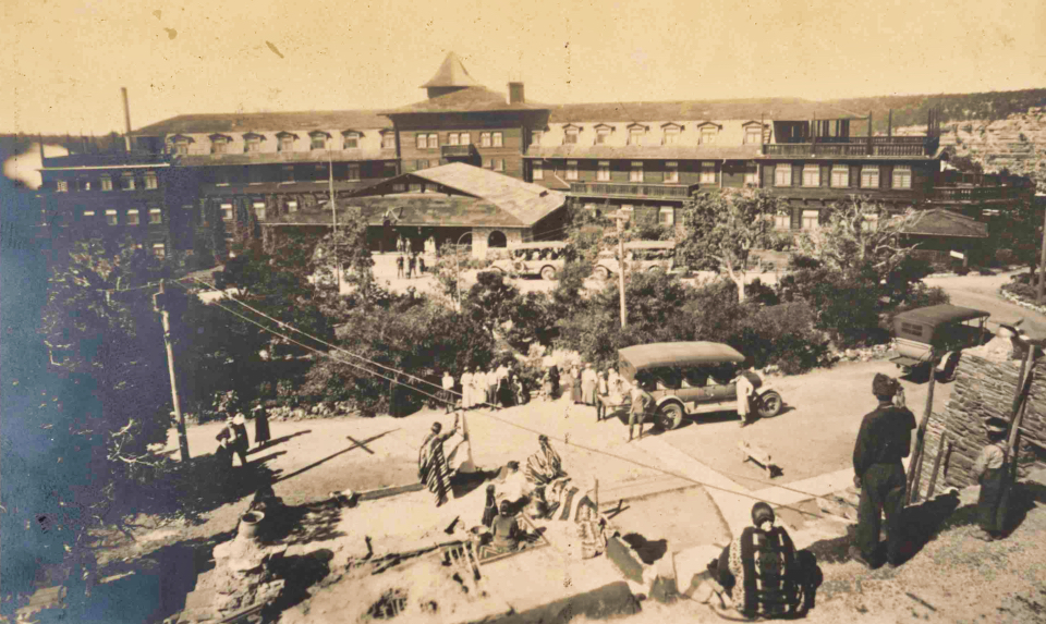 Large building, trees, cars, and people