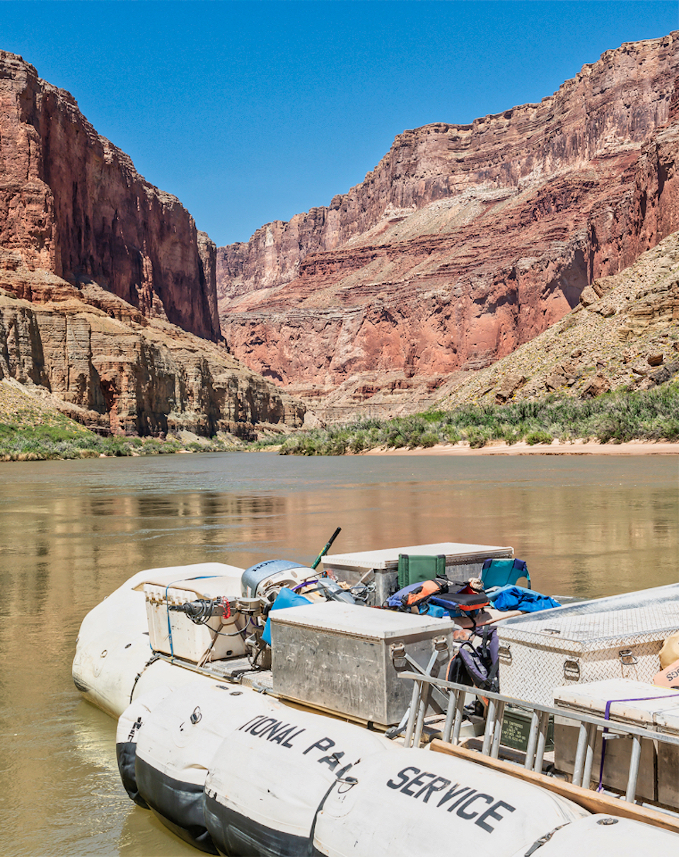 Rowing boat with chair on river with cliffs