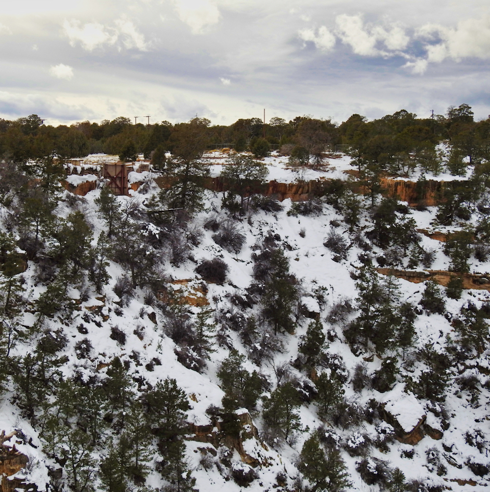 Rocky hillside with mining shaft tower on cliff edge