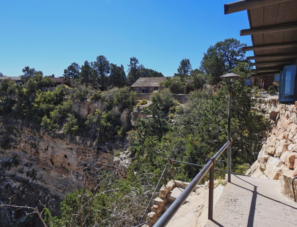 Cliff with fence and buildings behind