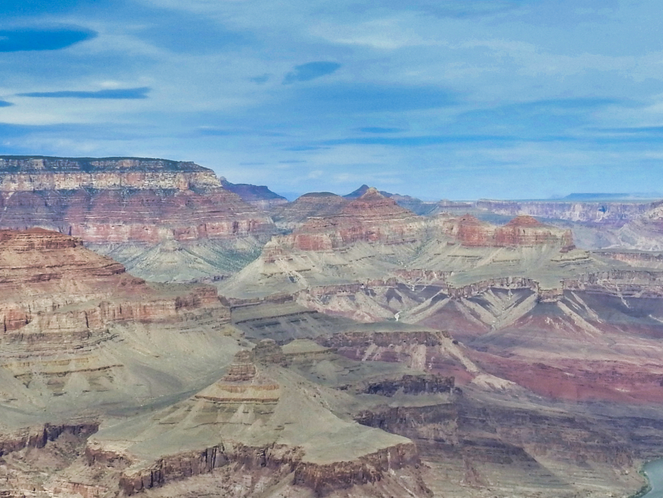 Painting of canyon landscape with many vibrant colors