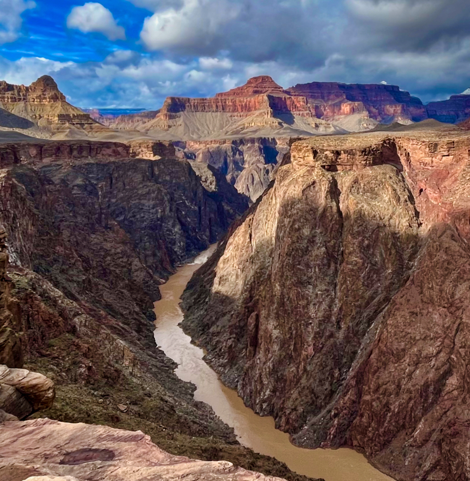 Painting of desert river canyon with river and distant mountains