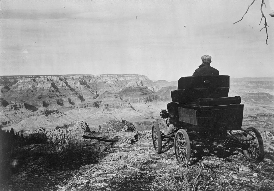 Historic car and driver on edge of cliff