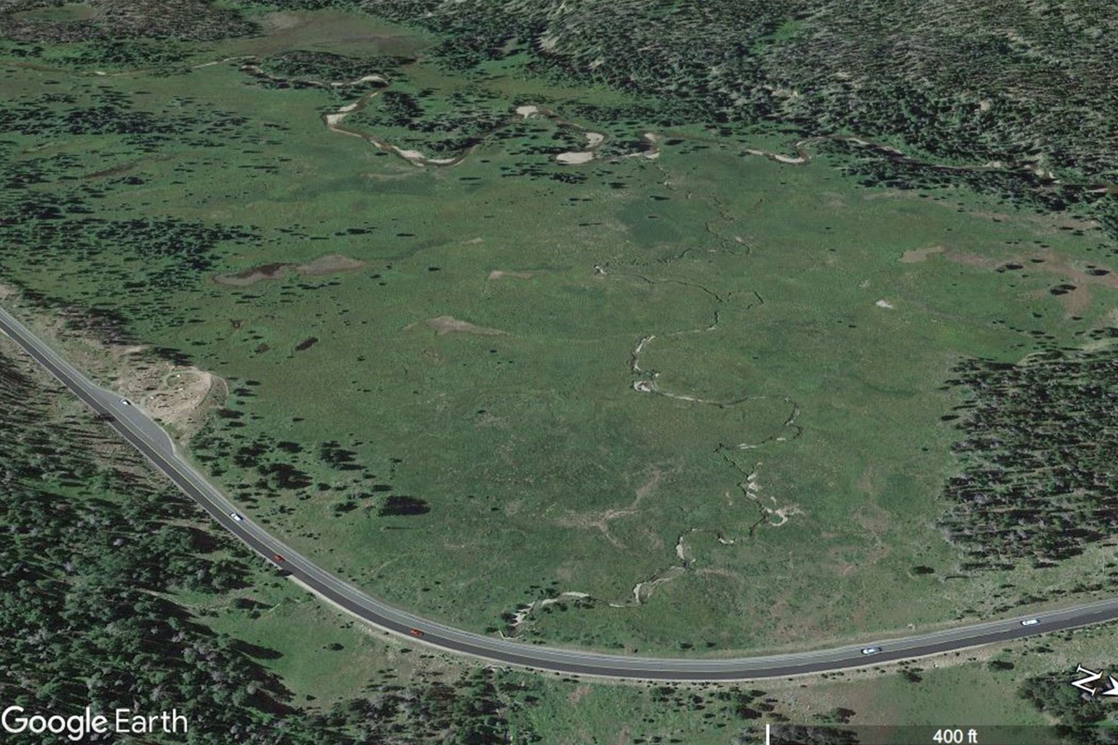 A historic, black and white photo of the Kawuneeche Valley that shows tall willow and standing water