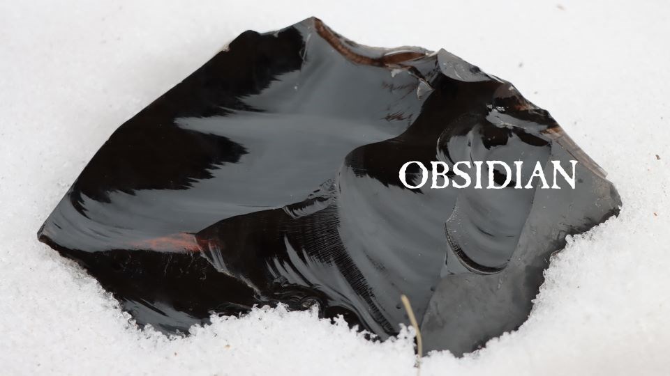 A piece of dark volcanic glass with the word "obsidian" over the image.