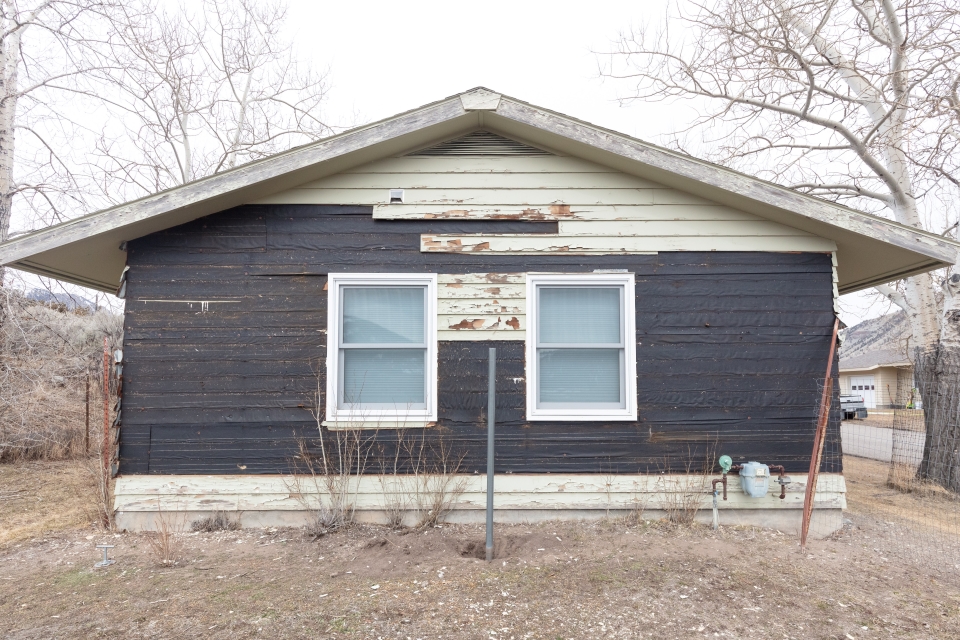 the side of a house that has weathered siding