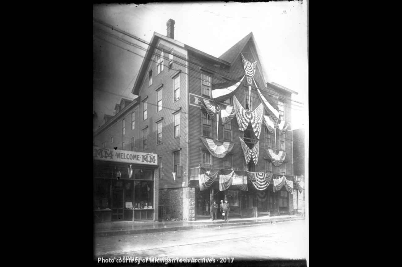 A historic black and white photo of the Oldfellows building in Calumet, MI