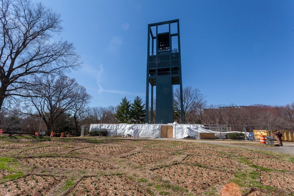 The Netherlands Carillon, blocked off by fencing and surrounded by caution cones and construction equipment. The trees have shed their leaves and the garden is not growing.