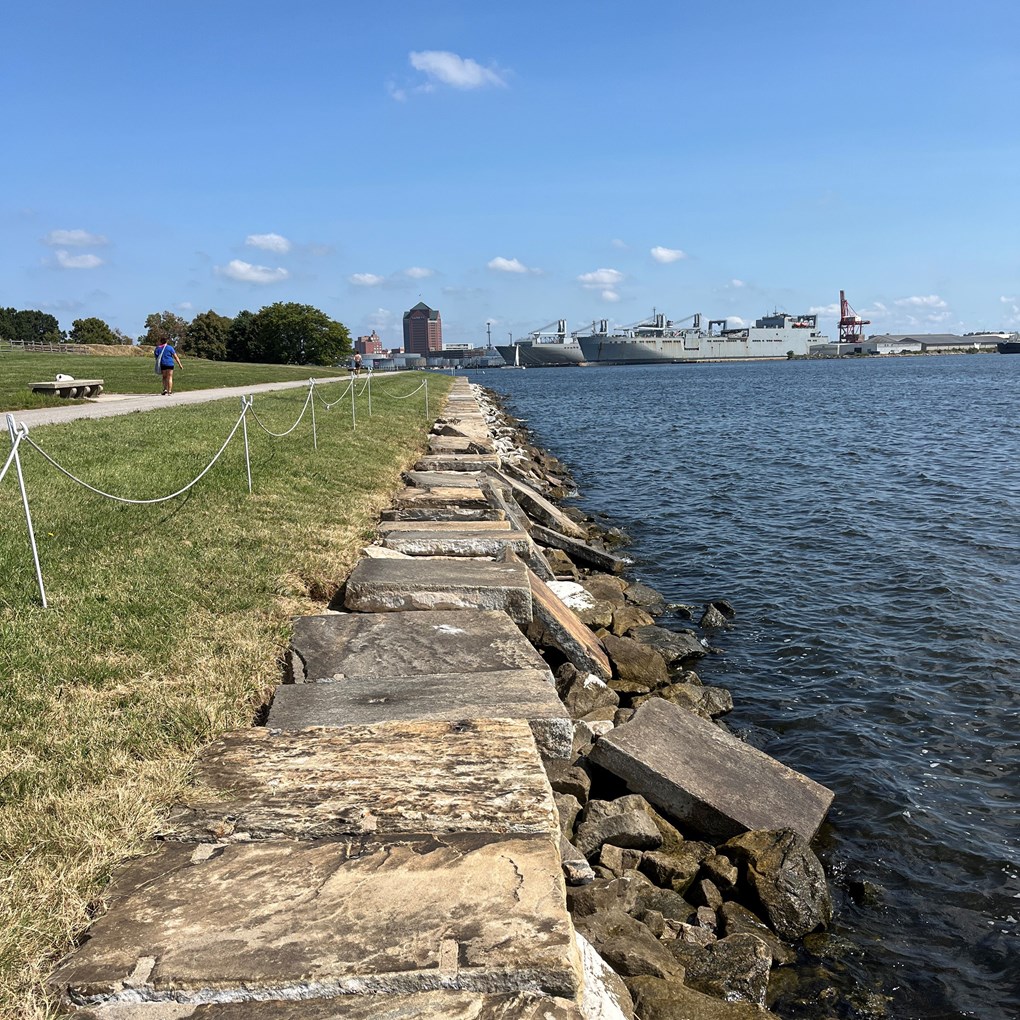 Seawall after storm damage. Capstone falling into river.