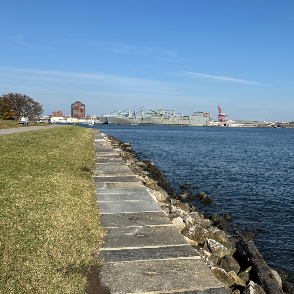 Seawall after storm damage. Capstone falling into river.