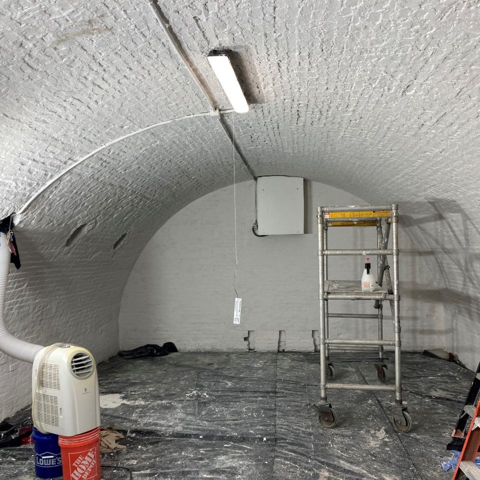 The interior of the bombproofs before the painting project, with paint peeling off the walls.