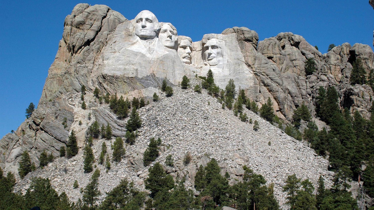 Black and white photo of Mount Rushmore as it appeared before carving began.