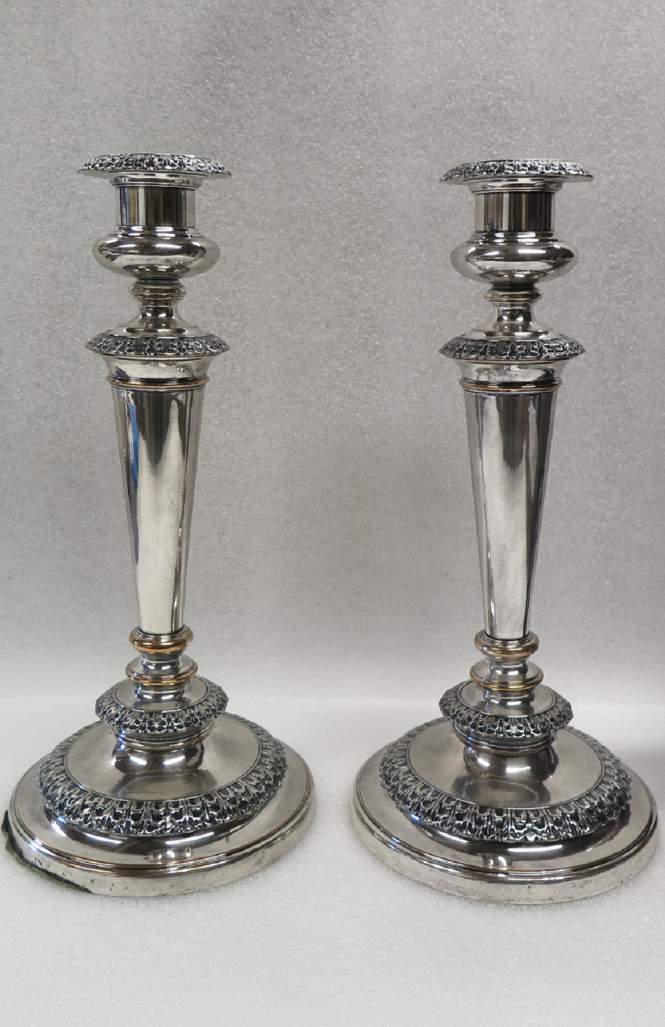 Two dark grey tarnished silver candlesticks.