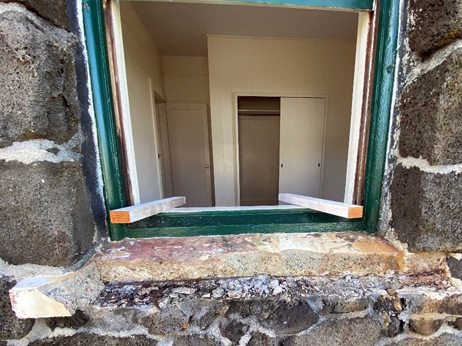 stone windowsill during repair. All crumbling material has been removed in preparation