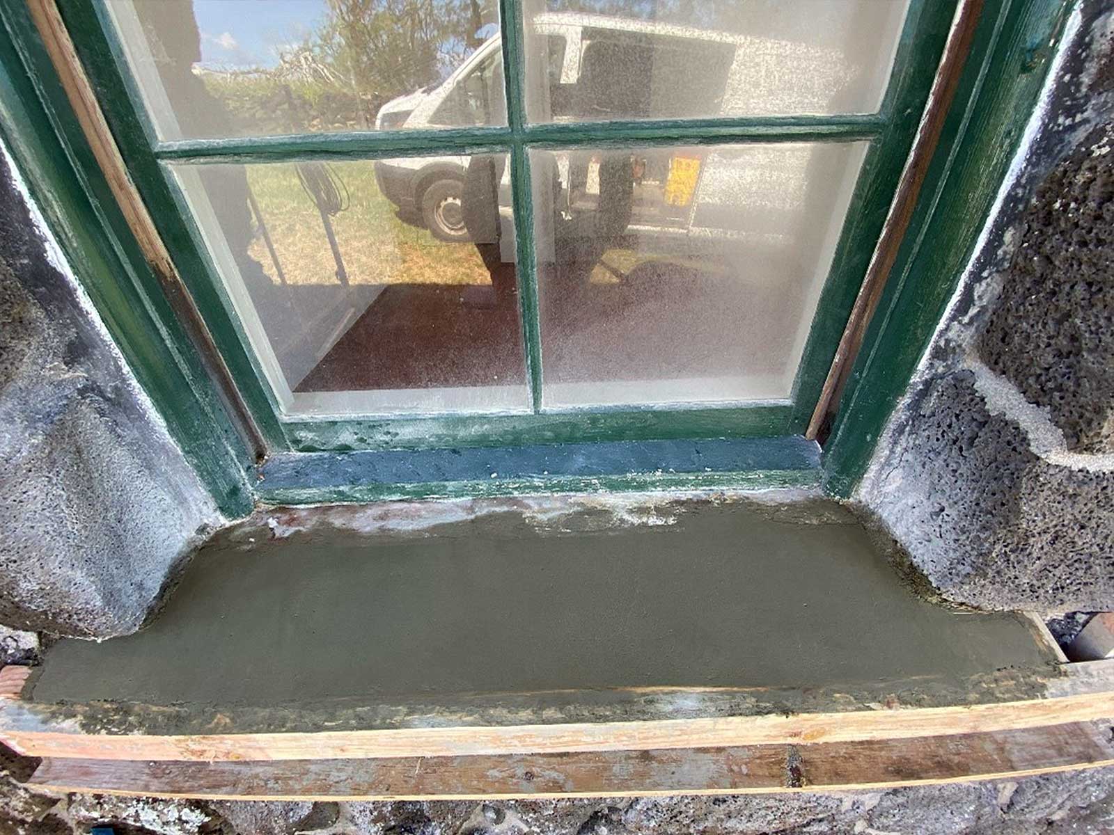stone windowsill during repair. All crumbling material has been removed in preparation