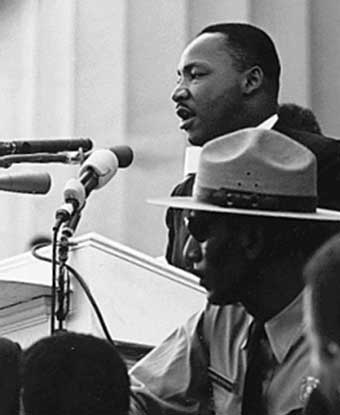 B&amp;W photo of MLK at podium with park ranger seated below