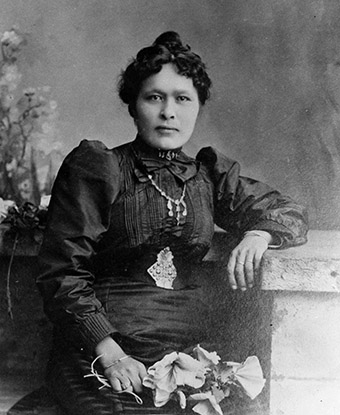 Black and white historic photo of woman in dress