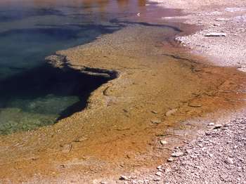 Close-up view showing the underwater ledge and deeper part of the hot spring.