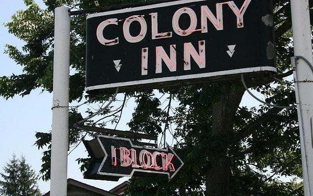 neon sign for the colony inn, which once occupied the Amana hotel