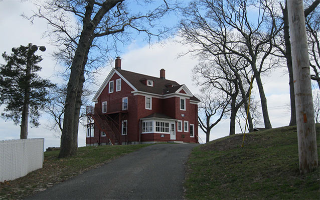 A two-and-a-half story, three-bay frame house with side-gabled roof. 