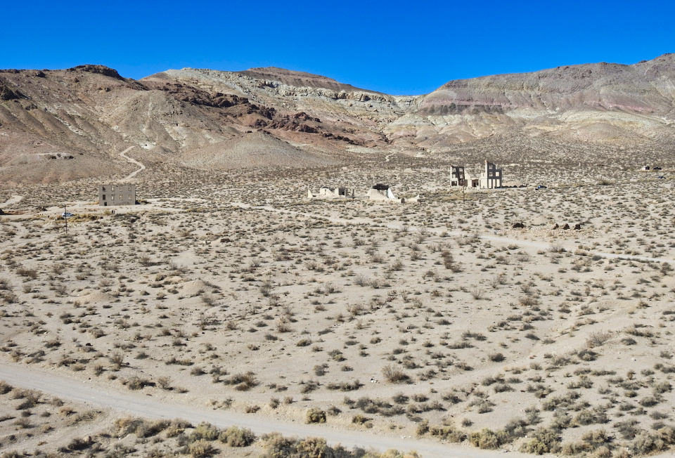 Buildings and streets with mountains in background.