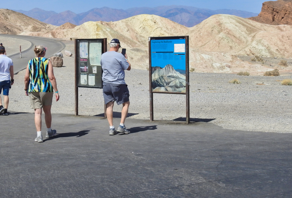 Concrete buildings in mud with mountains in background