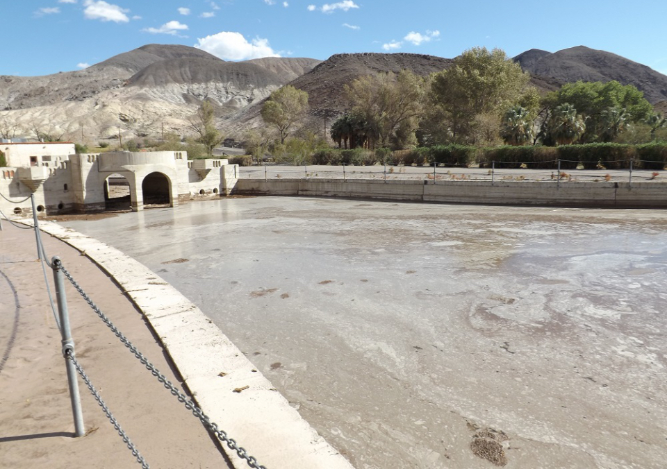 Large swimming pool filled with mud.