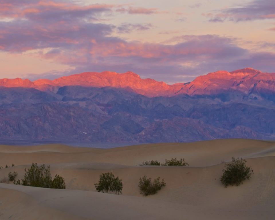 Colorful painting of hills and mountains in the desert.