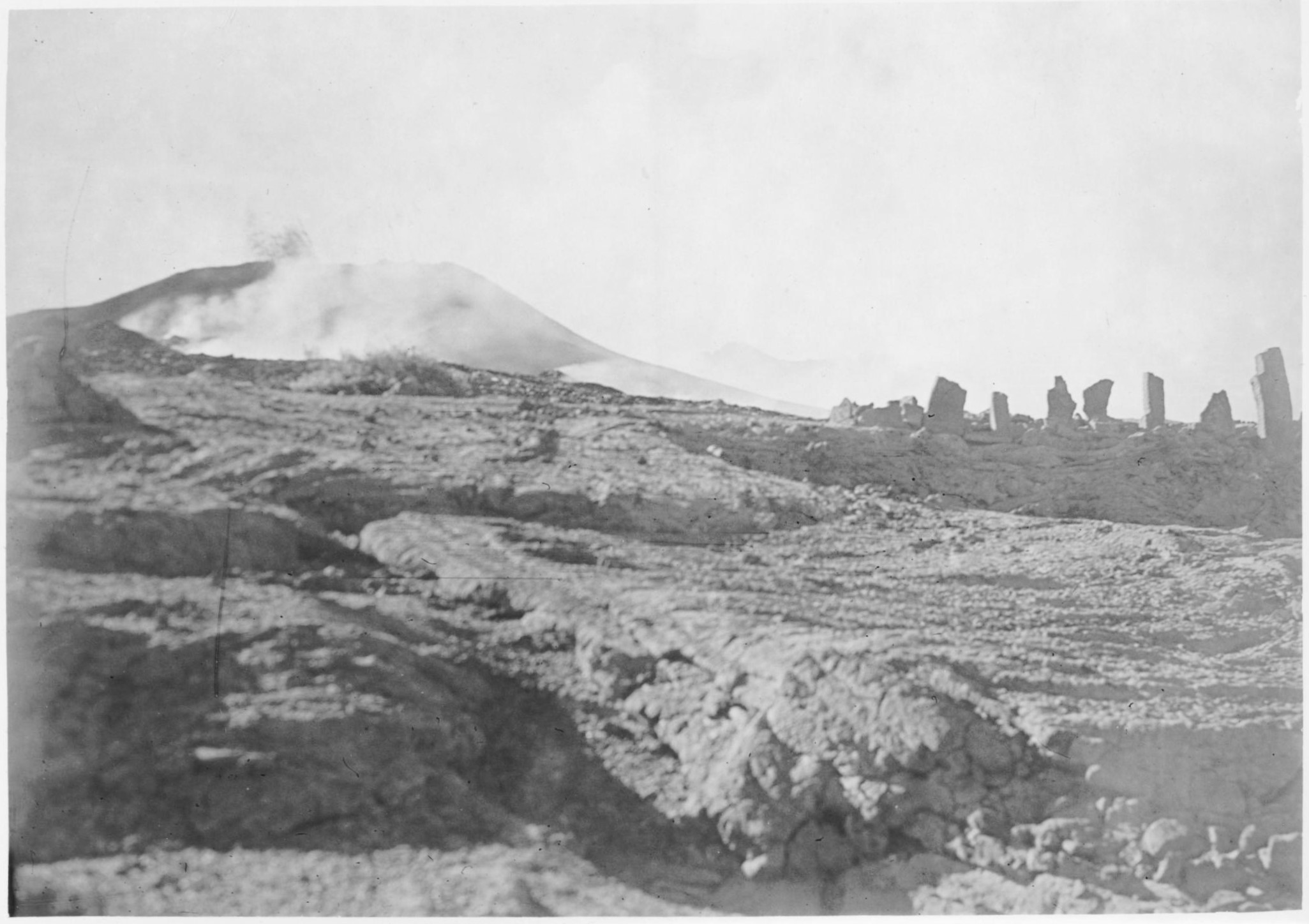 A black and white image of a cinder cone and stone altar.