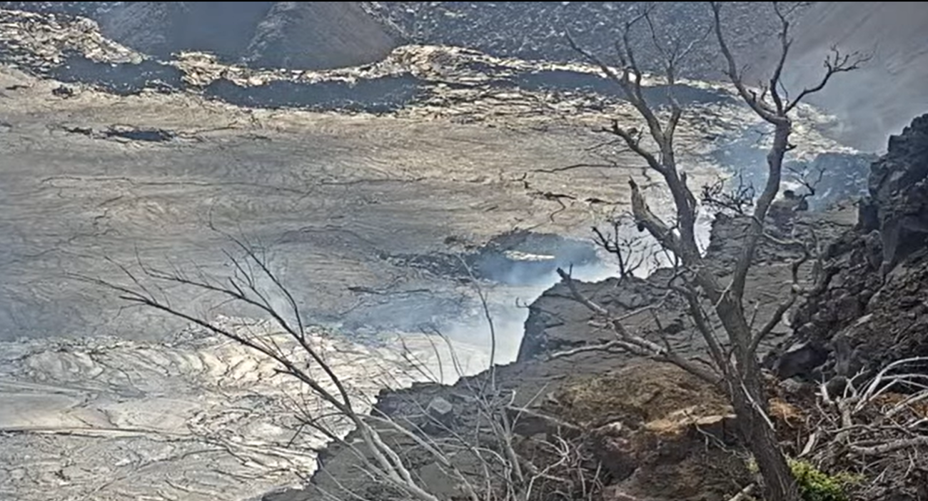 Webcam image of Halemaʻumaʻu crater with volcanic rock. No red lava is present in the crater.