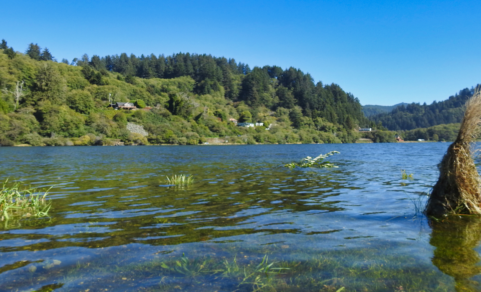 Old car on raft crossing river