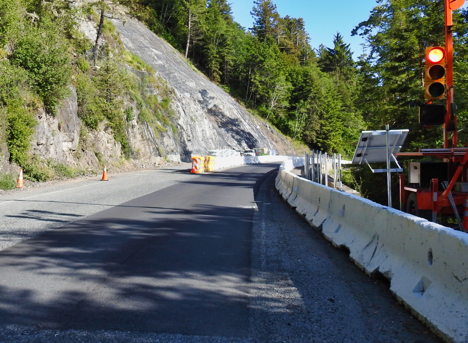 Tractor digging roadway on steep hillside