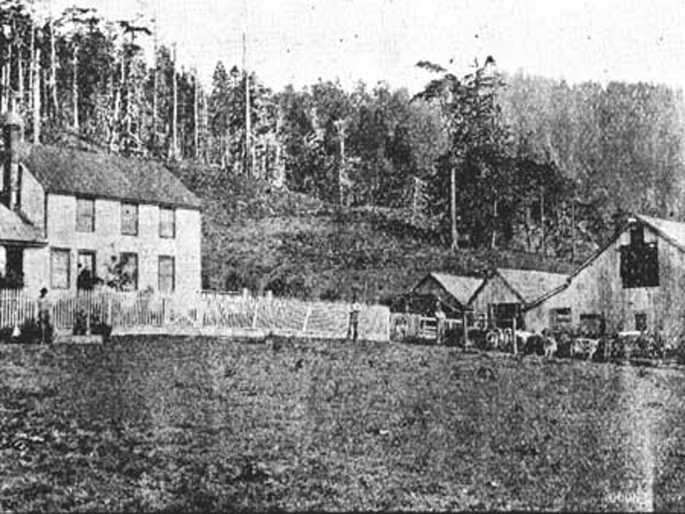 House and barns with meadows, trees, and hills
