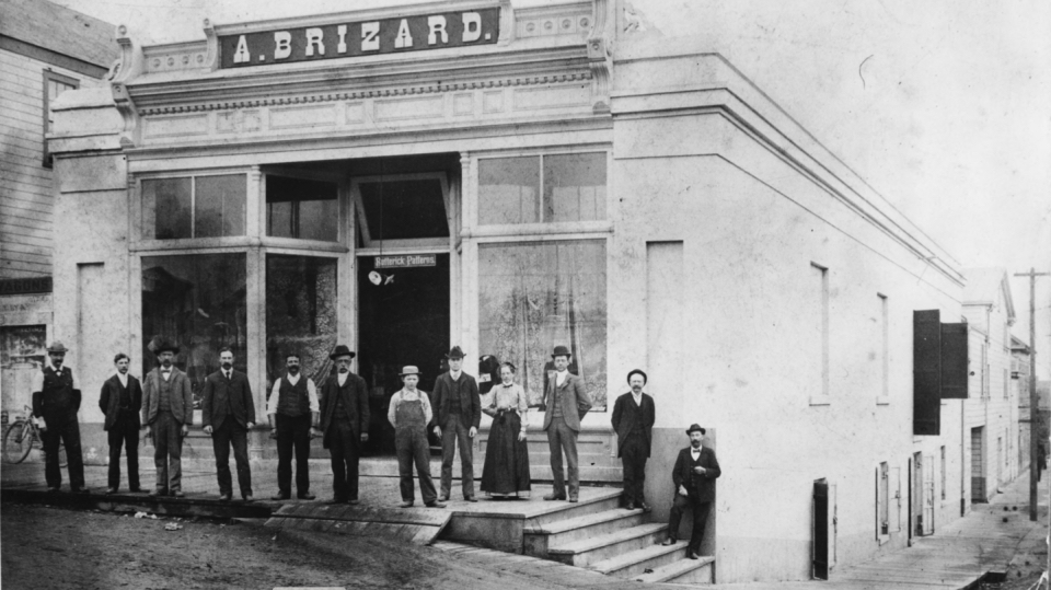 Building with men and a woman standing in front