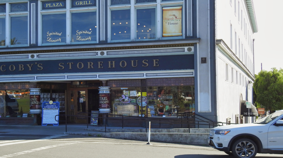Building with men and a woman standing in front